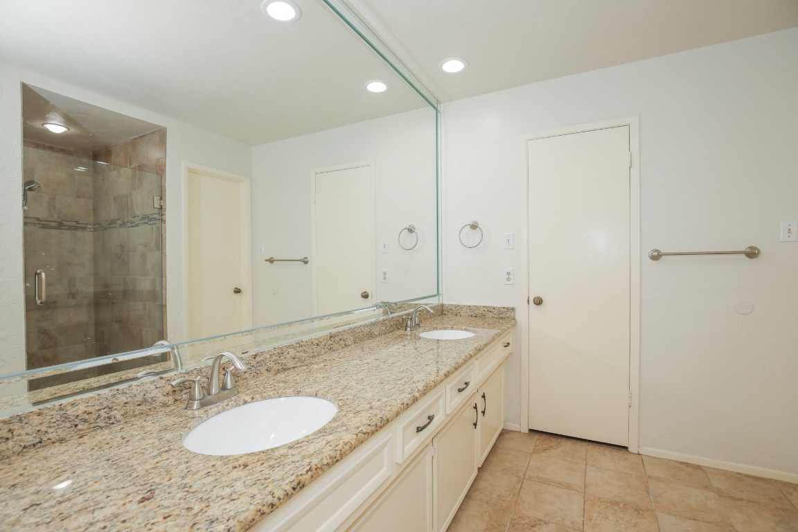 3003 Planters Street Sugar Land, TX 77479 - Photo 35 of 40 a bathroom with a granite countertop sink and a mirror