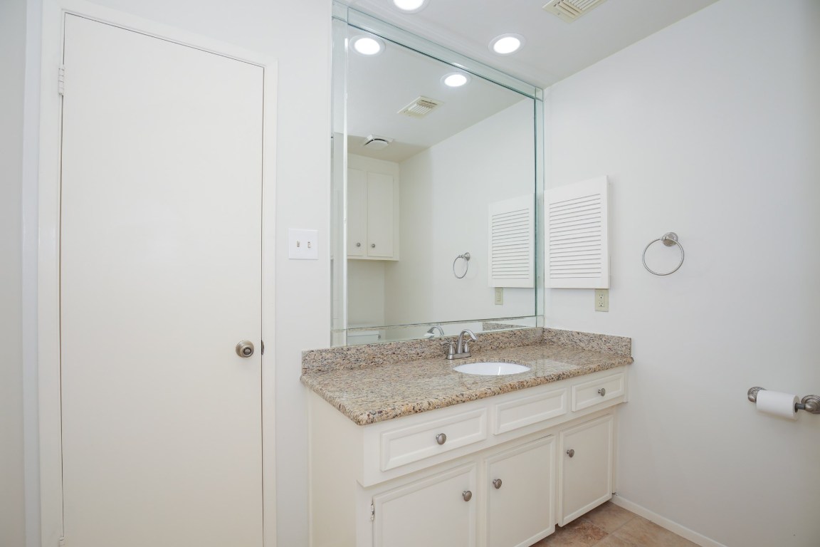 3003 Planters Street Sugar Land, TX 77479 - Photo 38 of 40 a bathroom with a granite countertop sink and a mirror