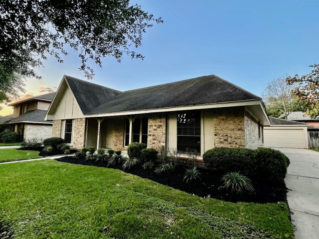 3003 Planters Street Sugar Land, TX 77479 - Photo 39 of 40 a front view of a house with a garden and trees