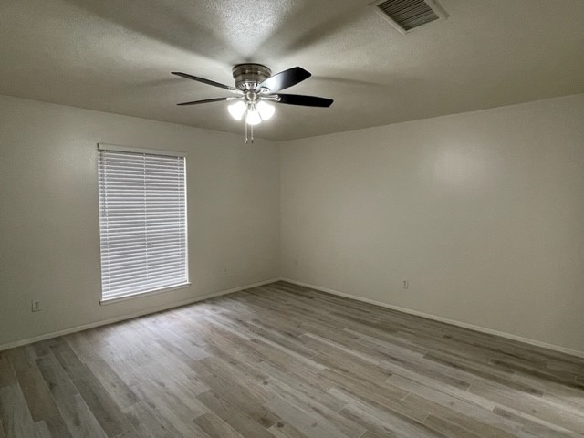 3003 Planters Street Sugar Land, TX 77479 - Photo 5 of 40 an empty room with wooden floor fan and windows