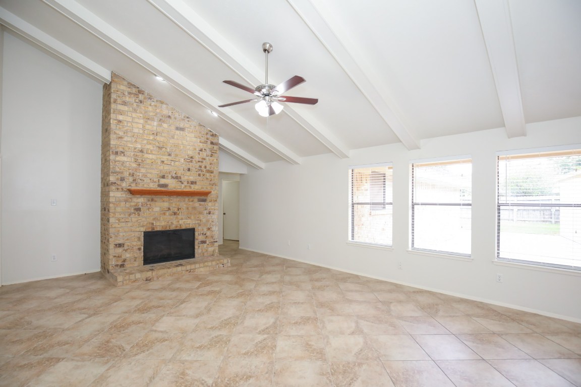 3003 Planters Street Sugar Land, TX 77479 - Photo 6 of 40 a view of empty room with fireplace fan and windows