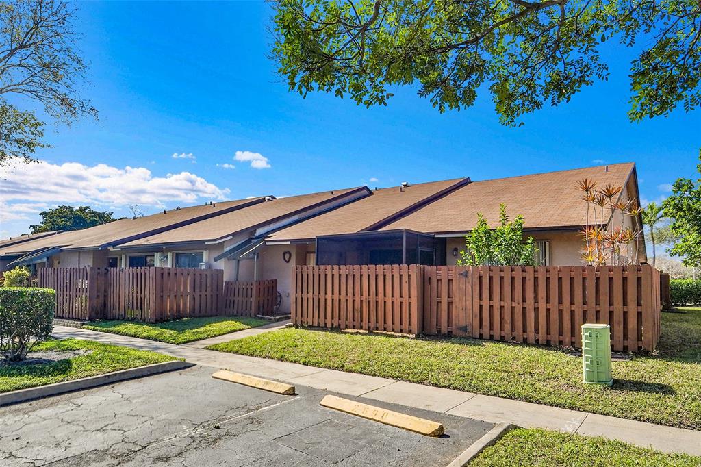 2698 North Nob Hill Road Sunrise, FL 33322 - Photo 19 of 27 a front view of a house with garden