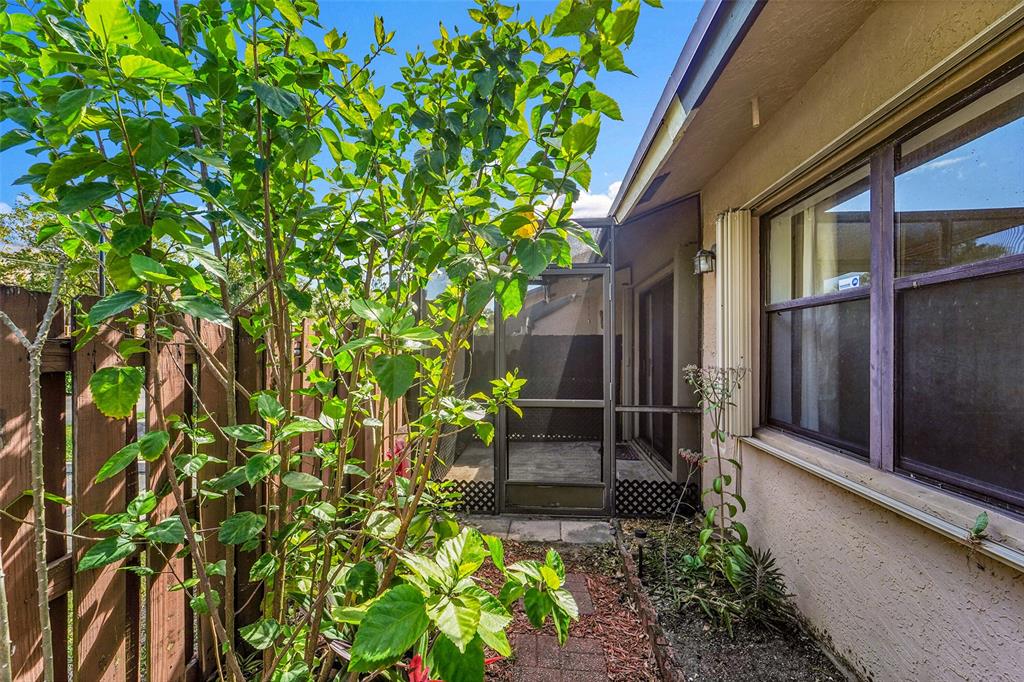 2698 North Nob Hill Road Sunrise, FL 33322 - Photo 22 of 27 a backyard of a house with lots of green space
