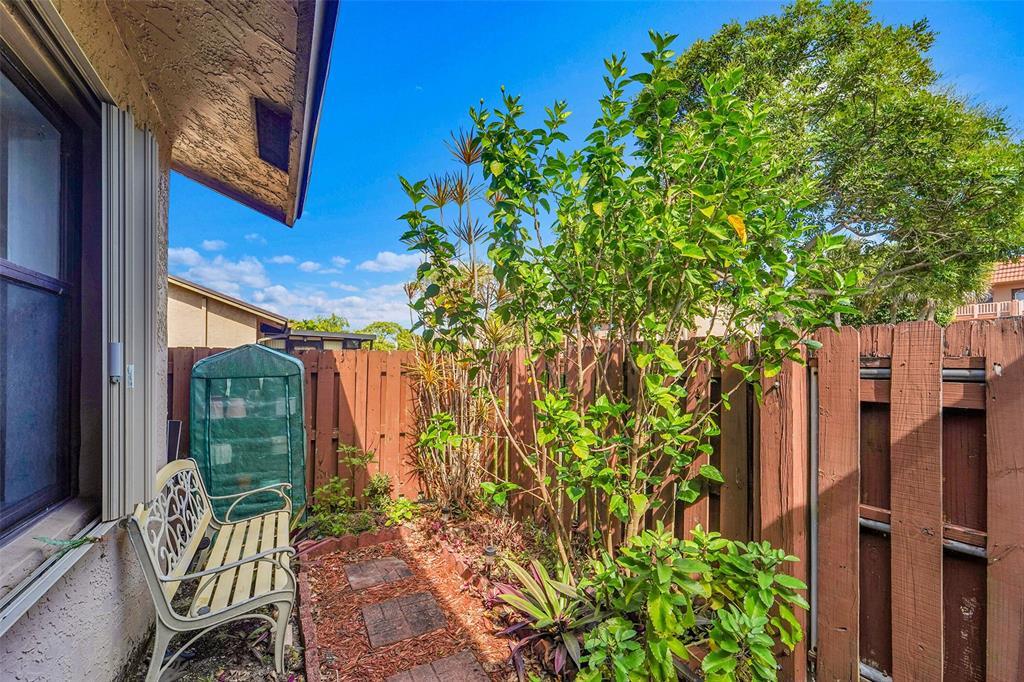 2698 North Nob Hill Road Sunrise, FL 33322 - Photo 24 of 27 a view of a chair and table in backyard of the house