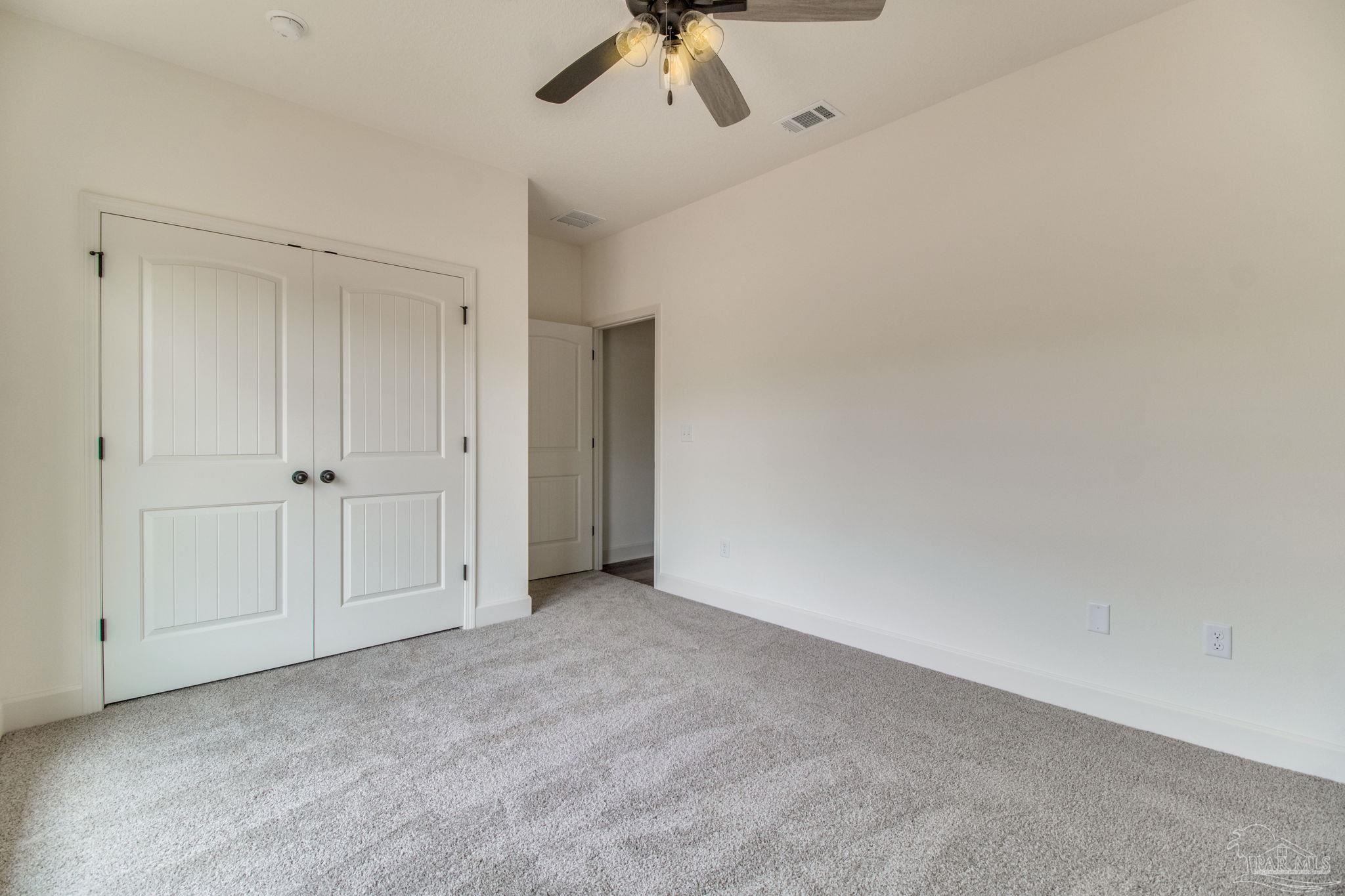 4310 Watkins Street Pace, FL 32571 - Photo 58 of 58 an empty room with a ceiling fan