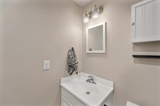 a view of a room with a ceiling fan and a window
