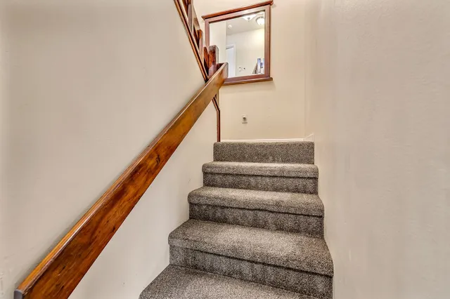 a living room with furniture rug and a window