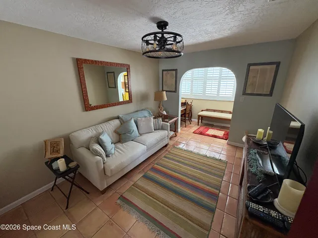 a living room with furniture a mirror and a window