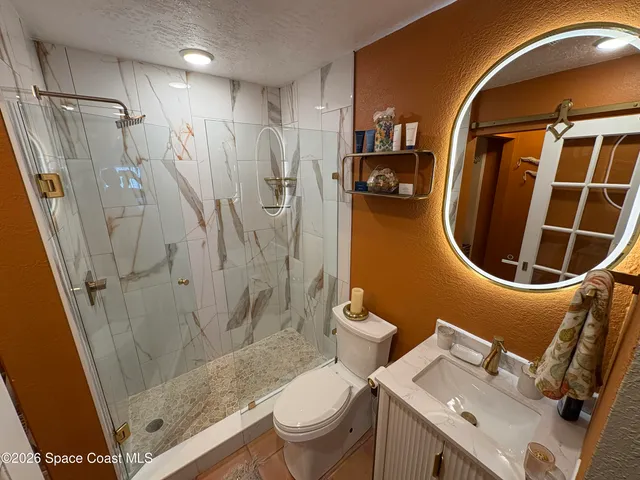 a bathroom with a sink toilet and shower