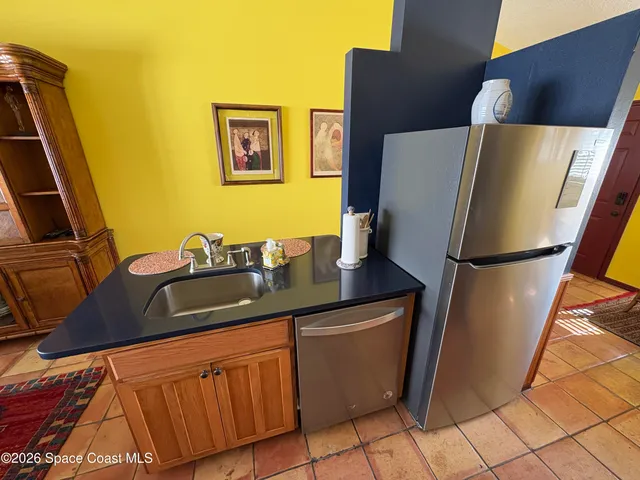 a kitchen with a refrigerator and a sink