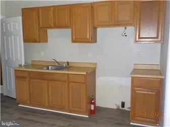 a utility room with granite countertop cabinets washer and dryer