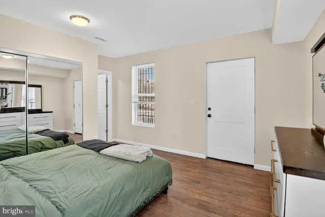 a bedroom with a bed and a dresser