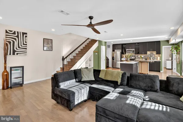 a living room with furniture and wooden floor