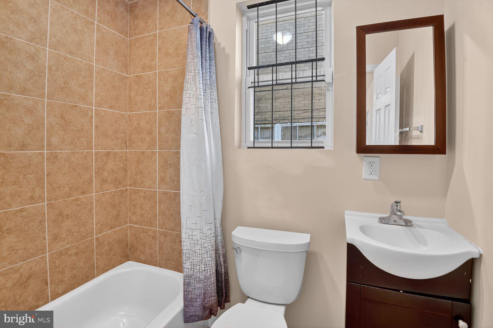 4321 Minnesota Avenue Northeast Washington, DC 20019 - Photo 21 of 24 a bathroom with a toilet a sink and a shower