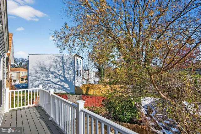 a view of a balcony with wooden fence
