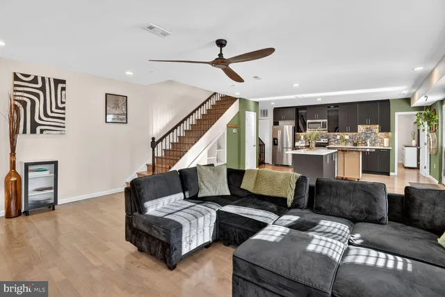 a living room with furniture and wooden floor