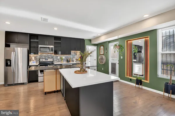 a kitchen with counter top space cabinets and stainless steel appliances
