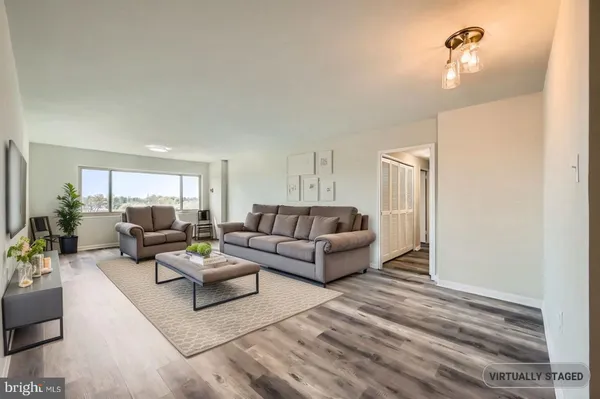 a view of kitchen with cabinets microwave and refrigerator