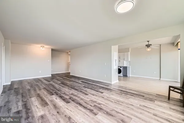 a view of a kitchen with a sink and dishwasher cabinets with wooden floor