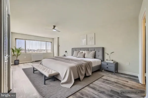 a view of a livingroom with wooden floor and a staircase