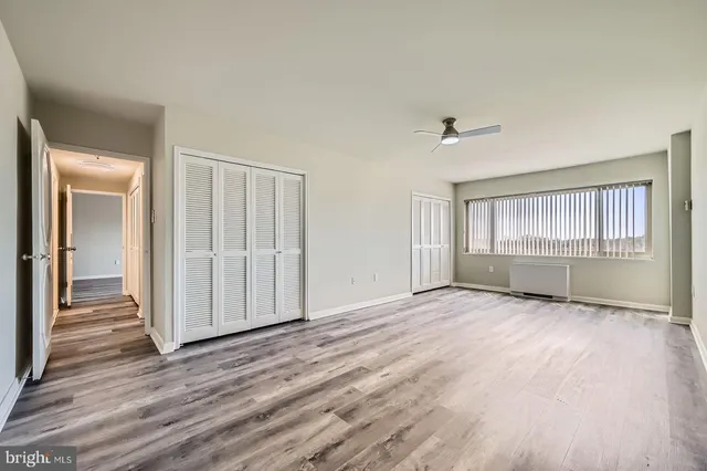 a spacious bedroom with a bed and a table