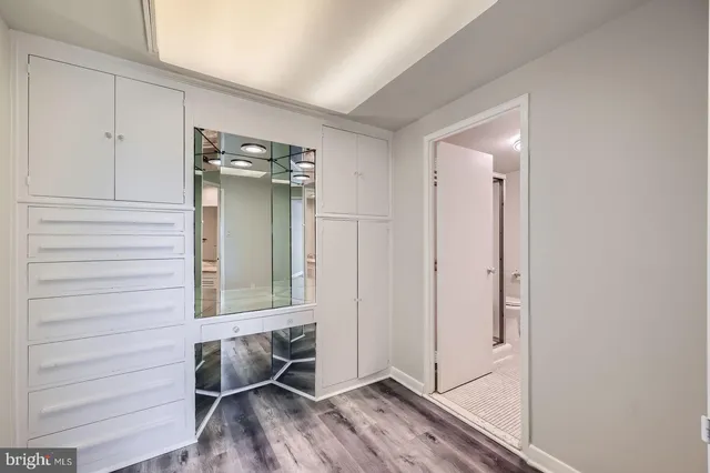 a bathroom with a granite countertop double vanity sink mirror and shower