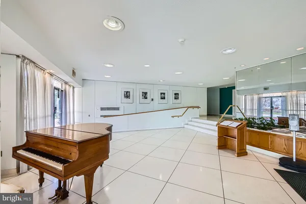 a living room with furniture and a pool table