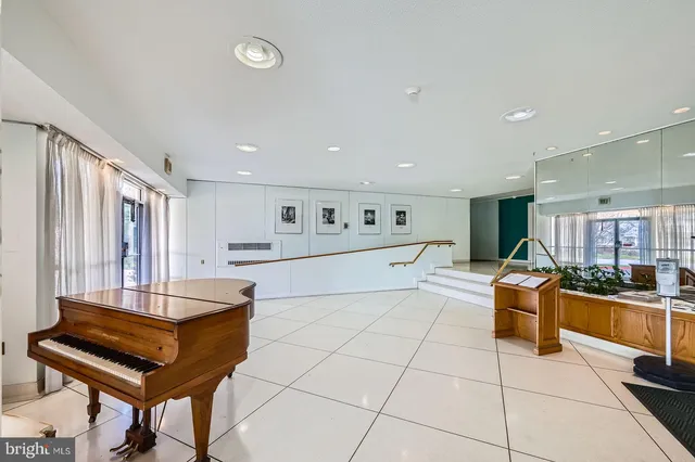 a living room with furniture and a pool table