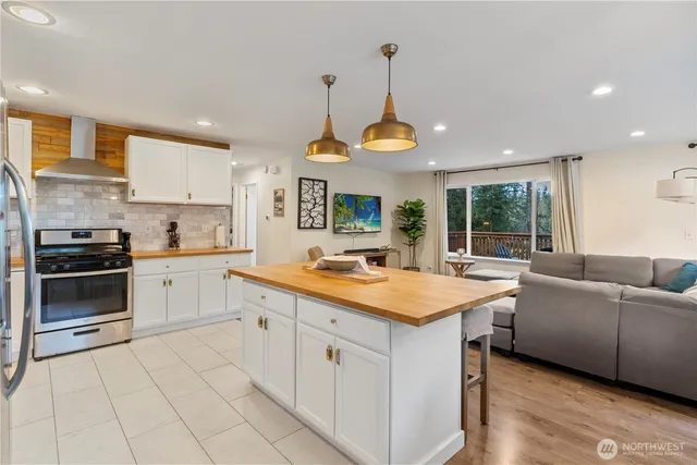 a kitchen with stainless steel appliances a stove sink and cabinets
