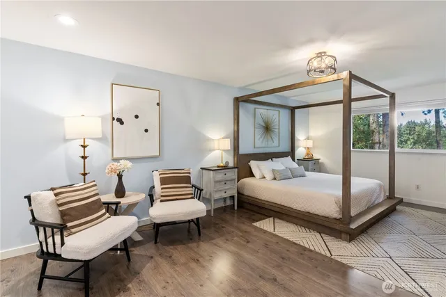 a bedroom with a large bed and a chandelier