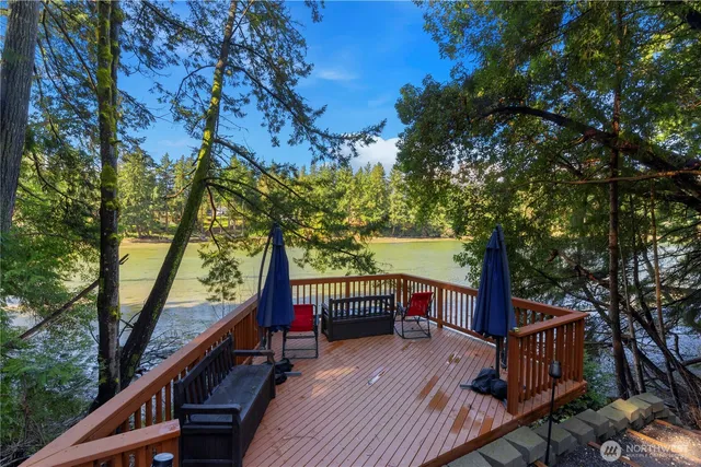 a view of deck with furniture and trees