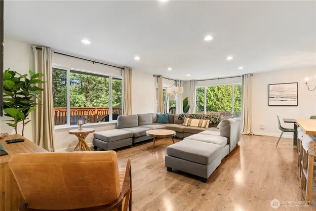 a kitchen with refrigerator a sink and chairs