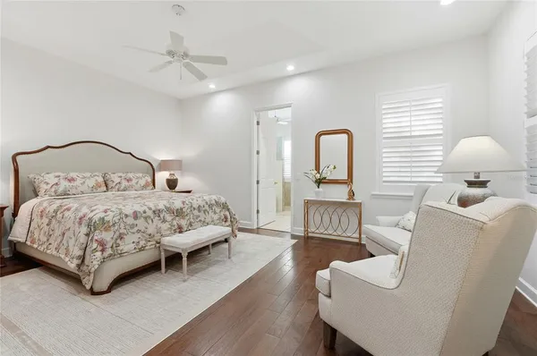 a bedroom with a large bed and a chandelier