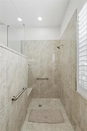 a bathroom with a granite countertop sink a toilet and a mirror