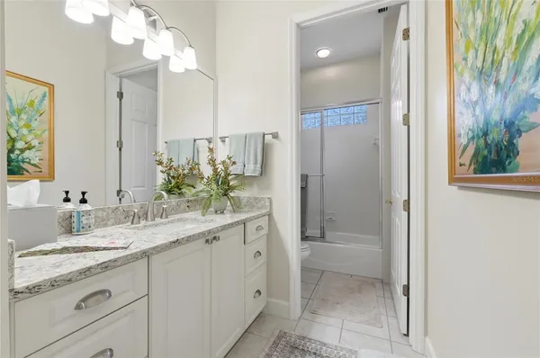 a bathroom with a shower a toilet and a sink