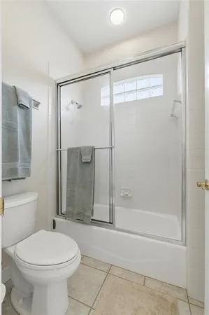 a bathroom with a toilet sink and shower