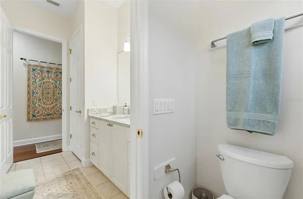 a bedroom with bed a chandelier and a window