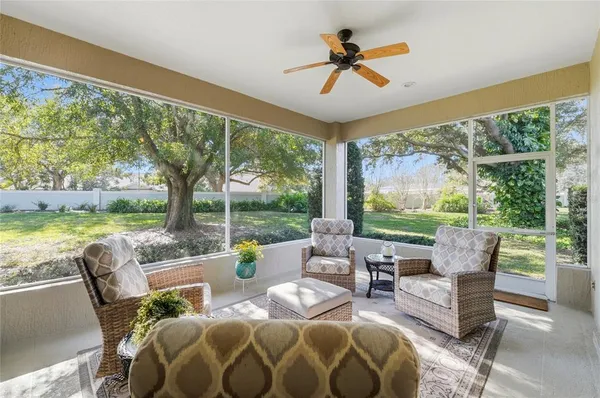 a living room with fireplace furniture and a floor to ceiling window