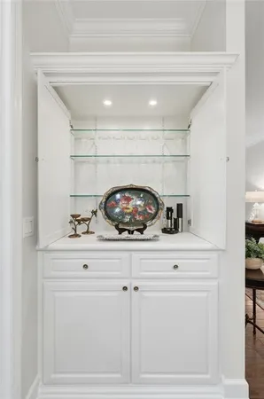 a living room with furniture a bed and a large window