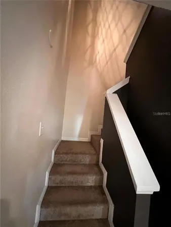 an empty room with windows and a ceiling fan