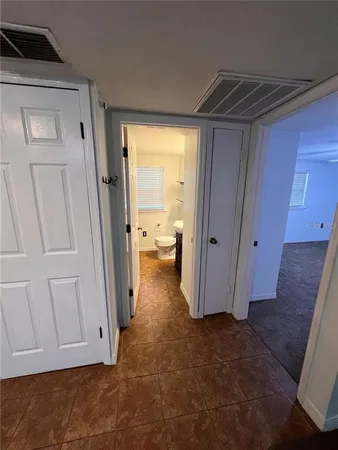a view of a livingroom with wooden floor and stairs