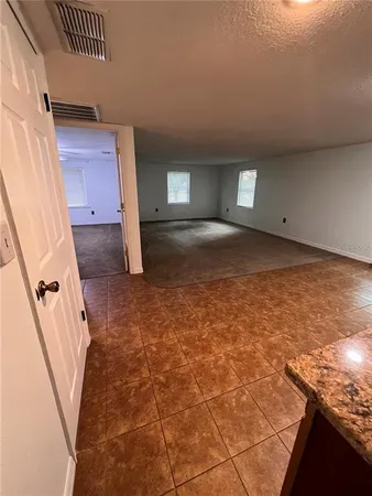 a view of a livingroom with a dishwasher and cabinets