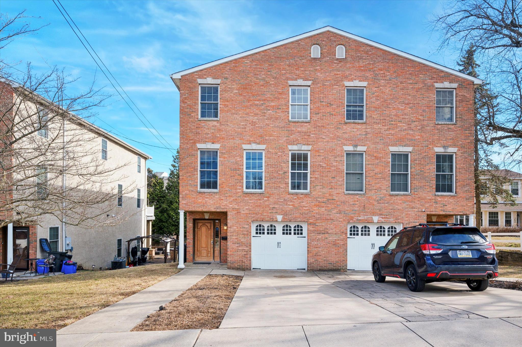 a car parked in front of a brick house