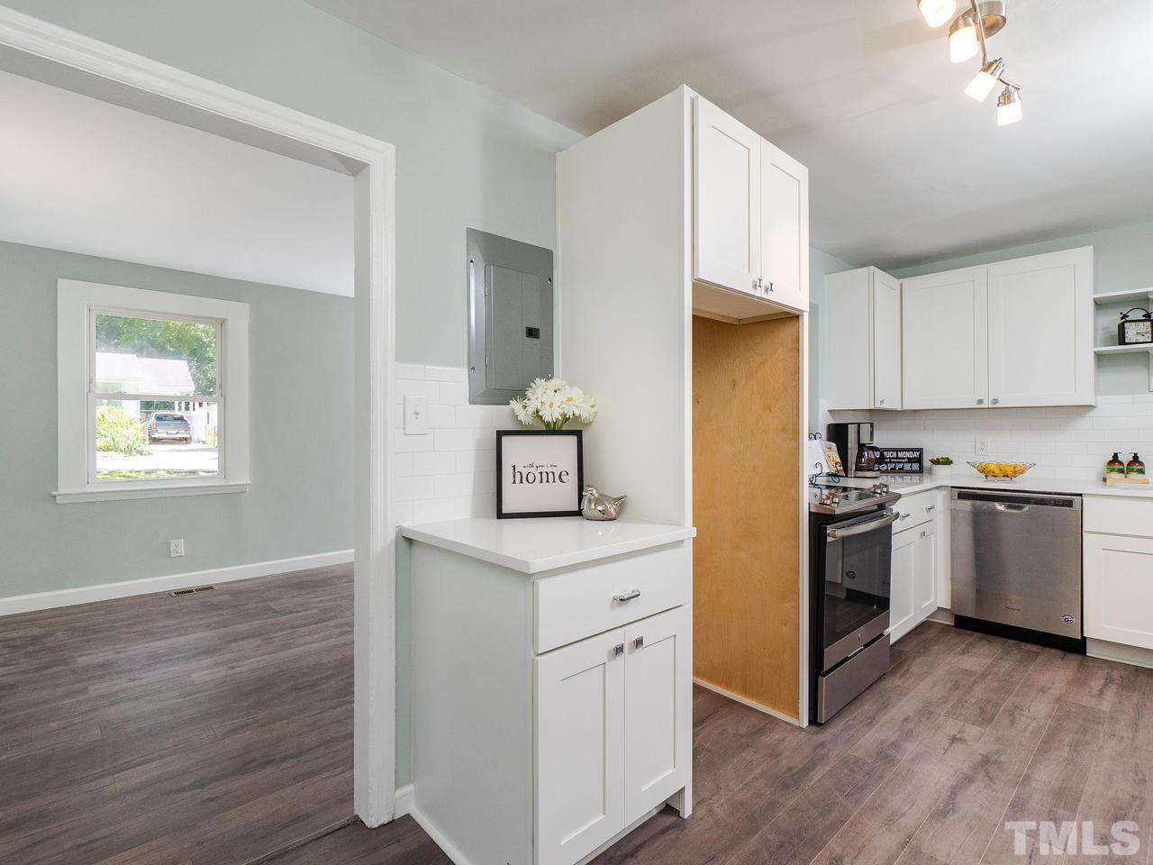332 Angier Avenue Raleigh, NC 27610 - Photo 23 of 30 a kitchen with a refrigerator stove and wooden floor