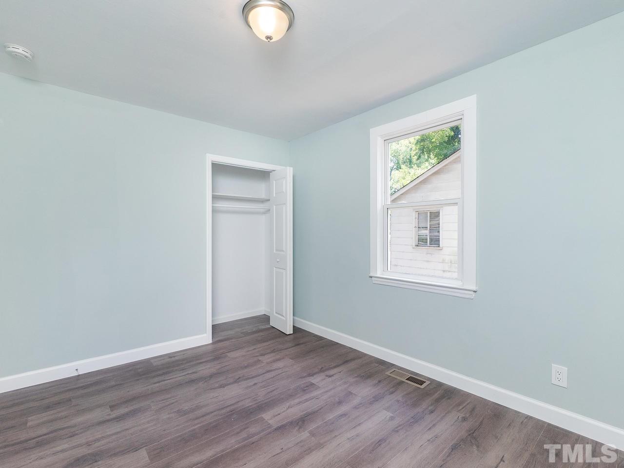 332 Angier Avenue Raleigh, NC 27610 - Photo 10 of 30 an empty room with wooden floor and windows