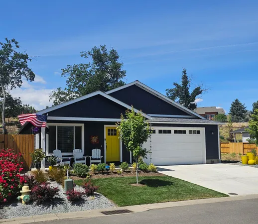 a front view of a house with porch and garden