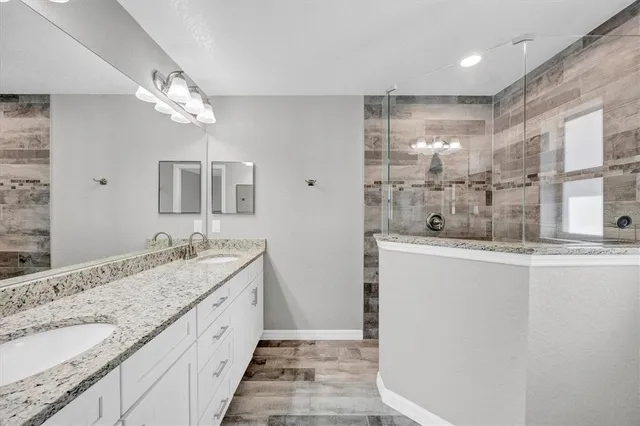 a bathroom with a granite countertop sink mirror and double