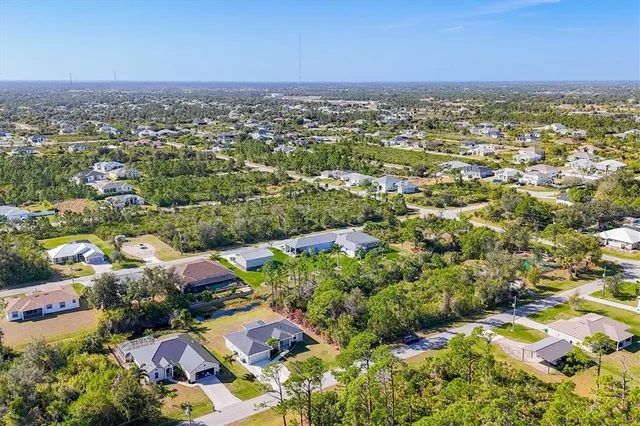 an aerial view of residential houses with outdoor space