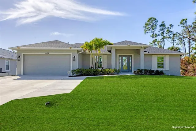 a front view of a house with a garden and yard