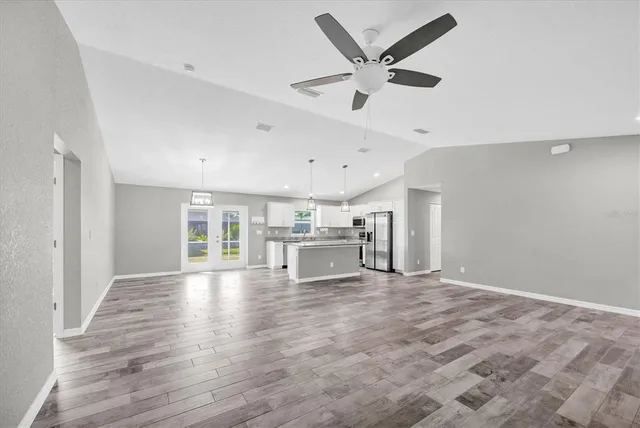 a view of a livingroom with a ceiling fan and wooden floor